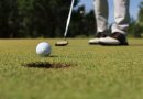 A person is practicing the timing of their golf swing in cold weather.